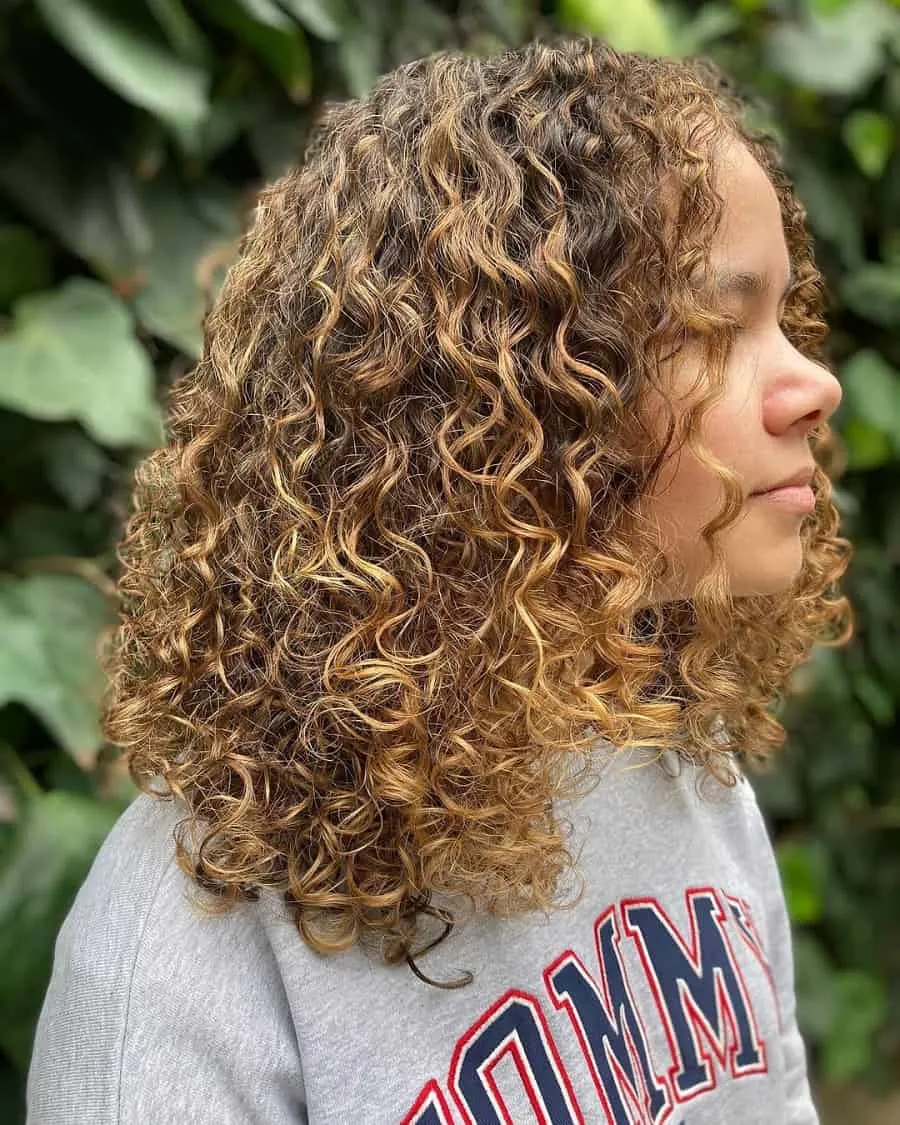 teenage girl curly hair with blonde highlights