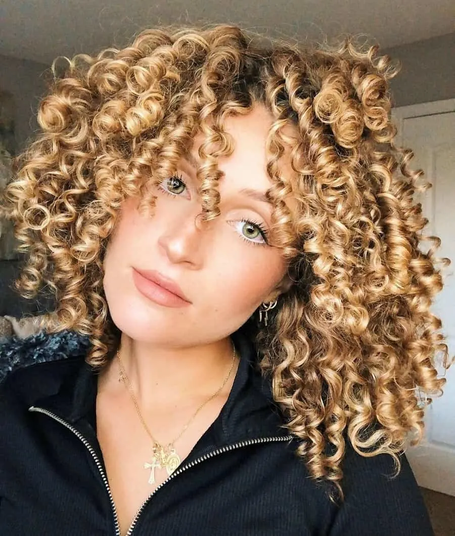 teenage girl curly hair with honey blonde highlights