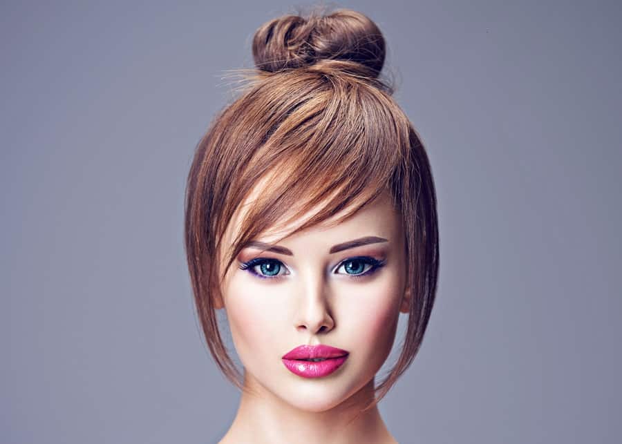 high bun hairstyle with side bangs