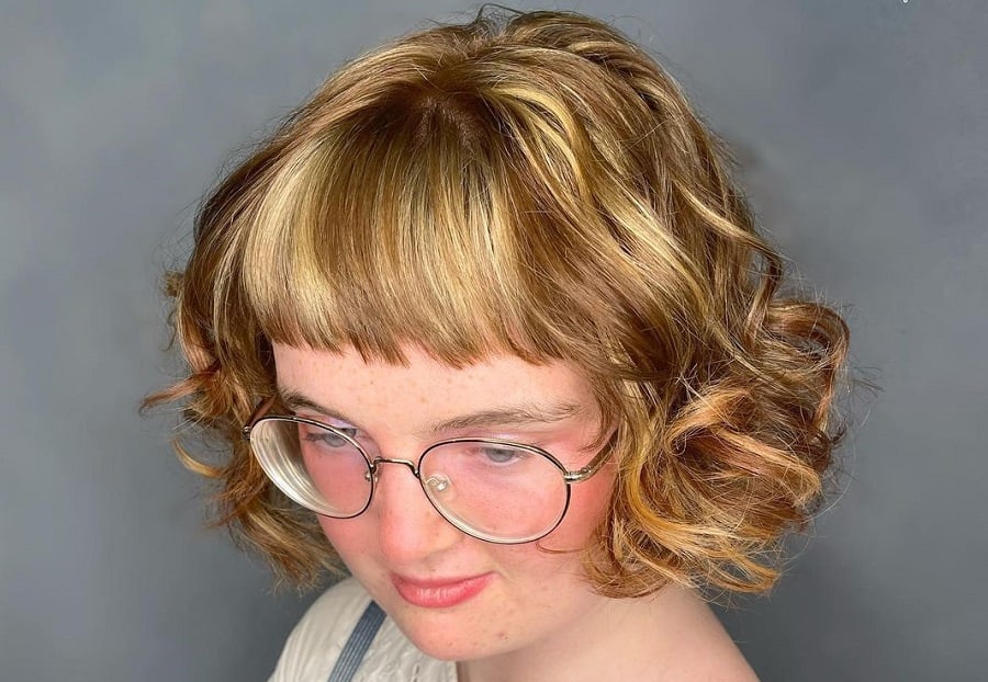 curly honey blonde bob with bangs