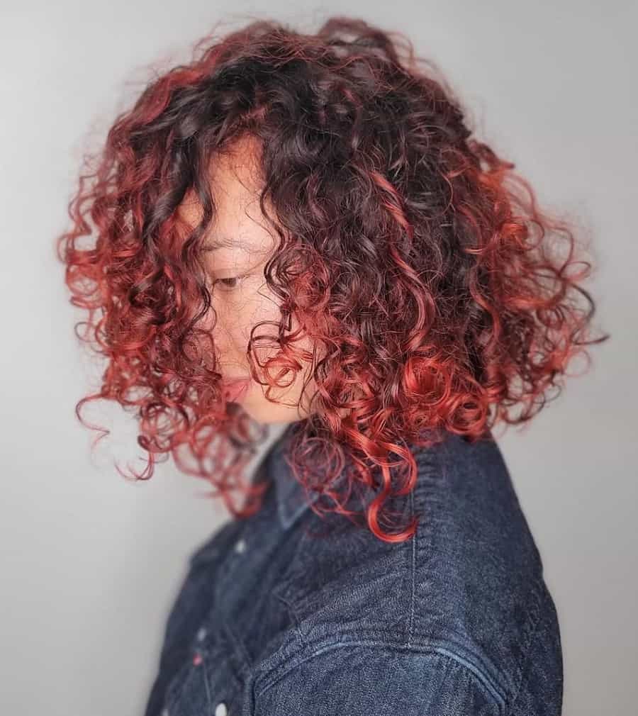 curly long bob with balayage red highlights