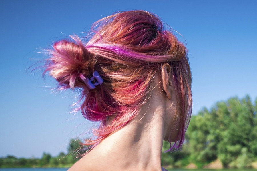messy updo with medium length thin pink hair