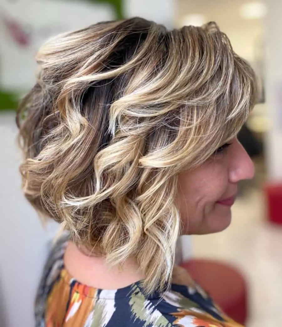 curly bob with blonde highlights for women over 50