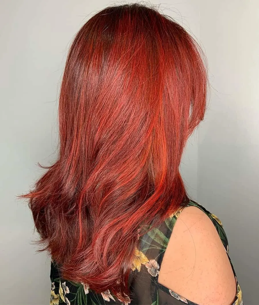 medium length hair with copper red highlights