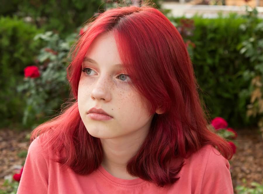 teenage girl with bright red hairstyle