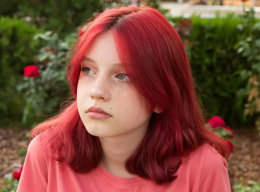 teenage girl with bright red hairstyle