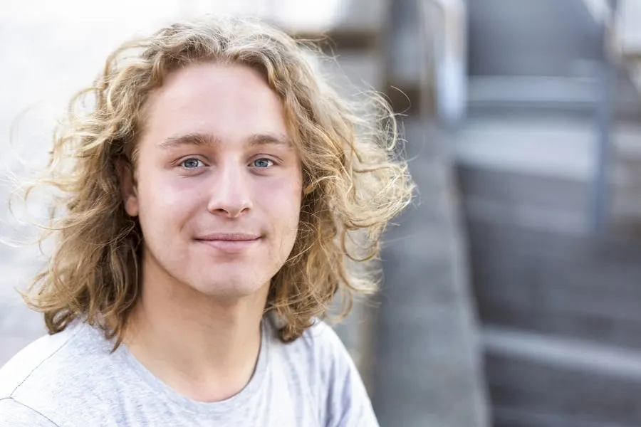 young guy with long curly blonde hair