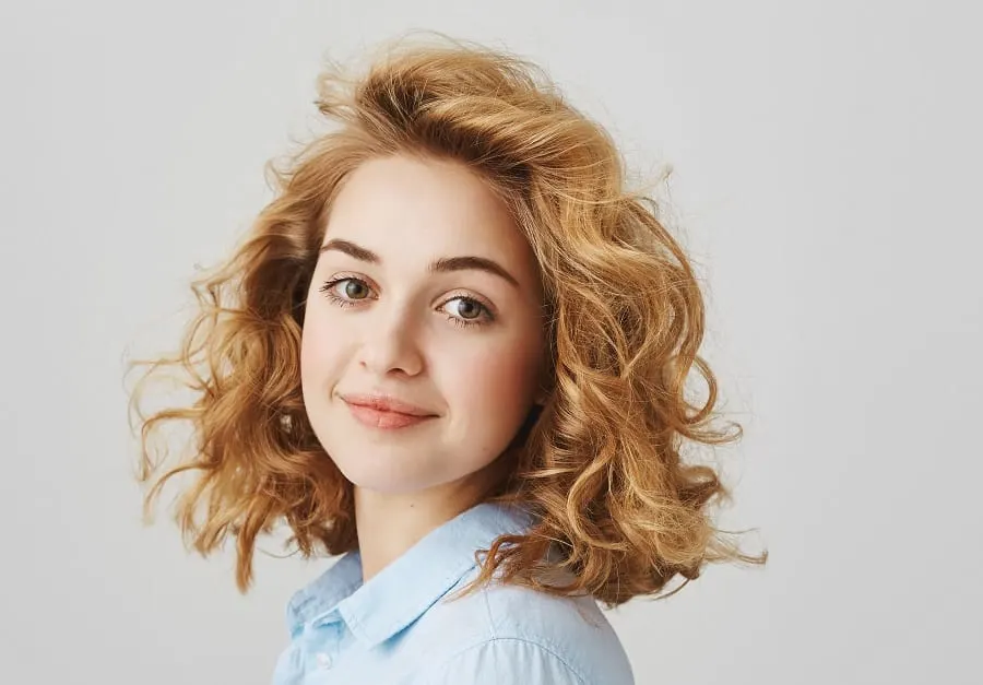 young woman with low maintenance curly blonde hairstyle