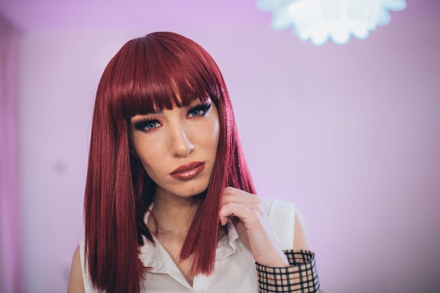 medium red blunt hairstyle with bangs