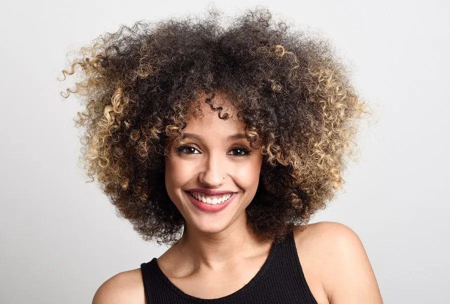 medium afro hair with blonde highlights