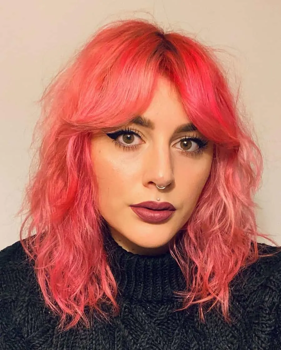medium shaggy hairstyle with pastel pink hair