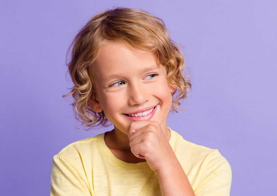 little kid with long blonde curly hair