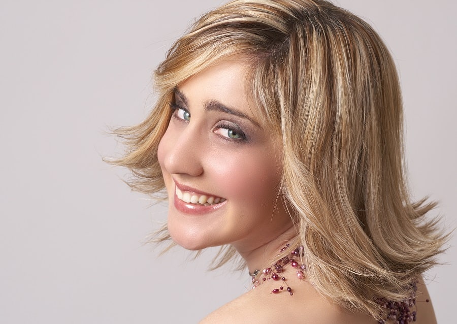 flip hairstyle with layered blonde bob
