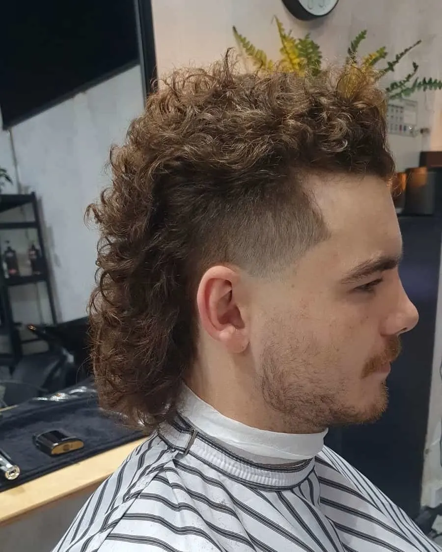 guy with curly mullet hairstyle