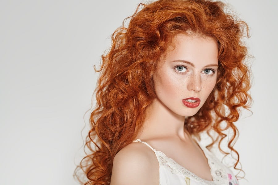 long layered hairstyle with curly ginger red hair