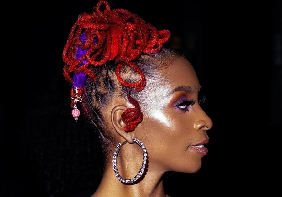 red locs hairstyle with bun
