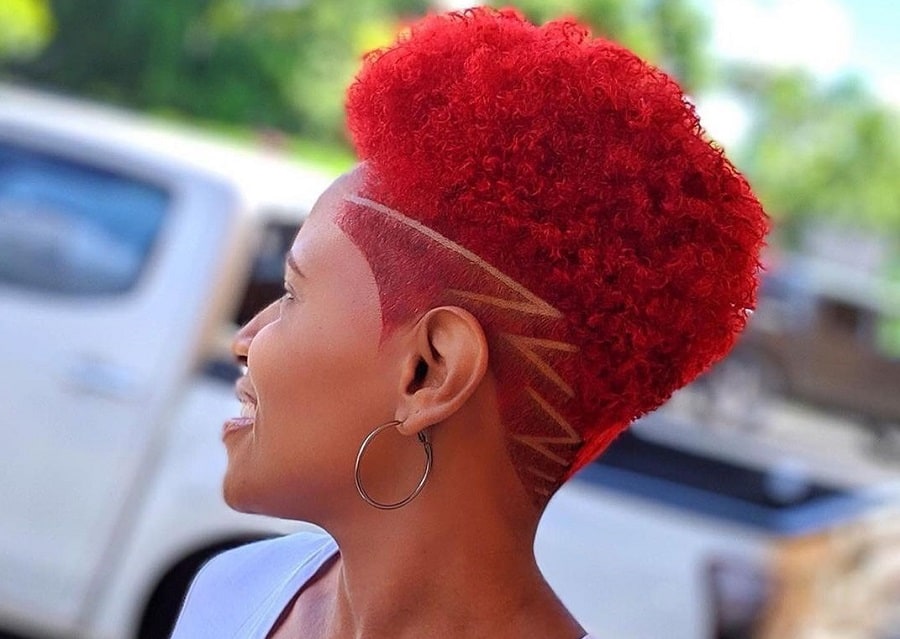 woman's red afro hair with low fade and design