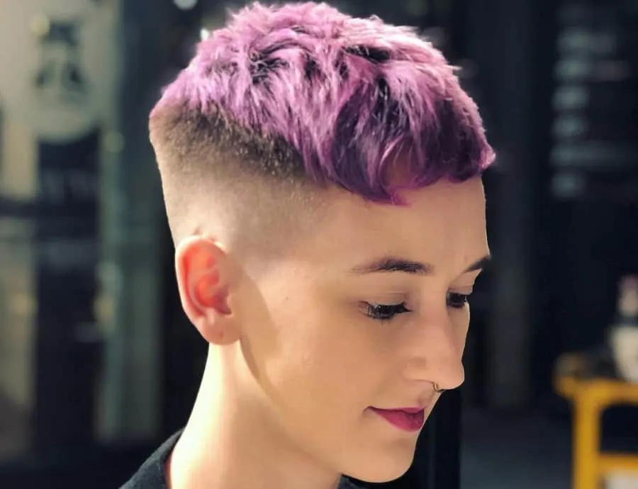 woman with short purple hair and mid fade