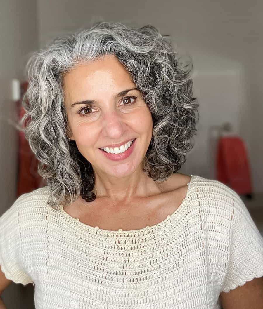 older woman with curly grey hairstyle