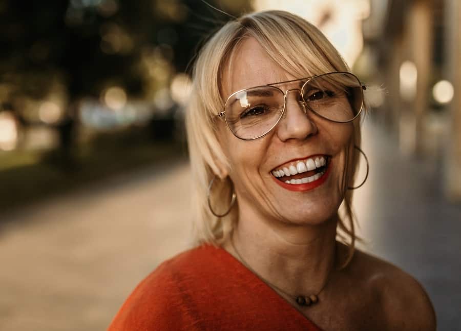 woman over 50 with glasses and short blonde hair