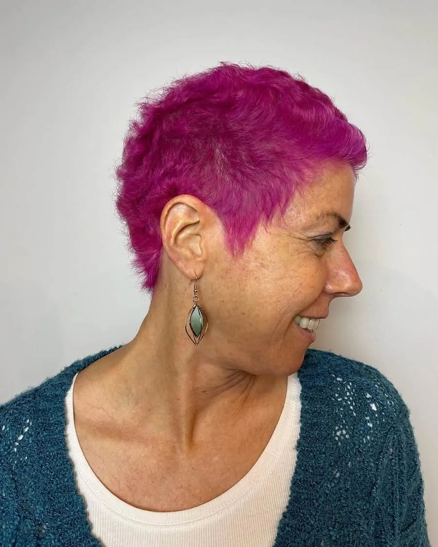 older woman with short pink hair