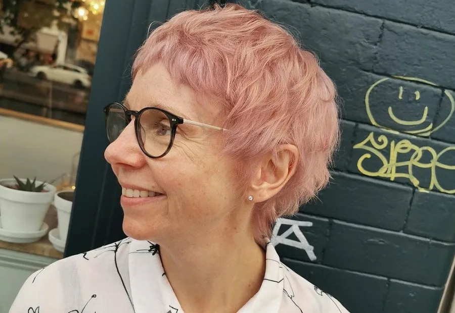 woman over 50 with curly short pink hair
